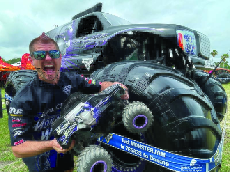 Three screaming mohawks in one photo—Bryce Kenny, his Mohawk Warrior monster truck and its 1/10 RC replica. 