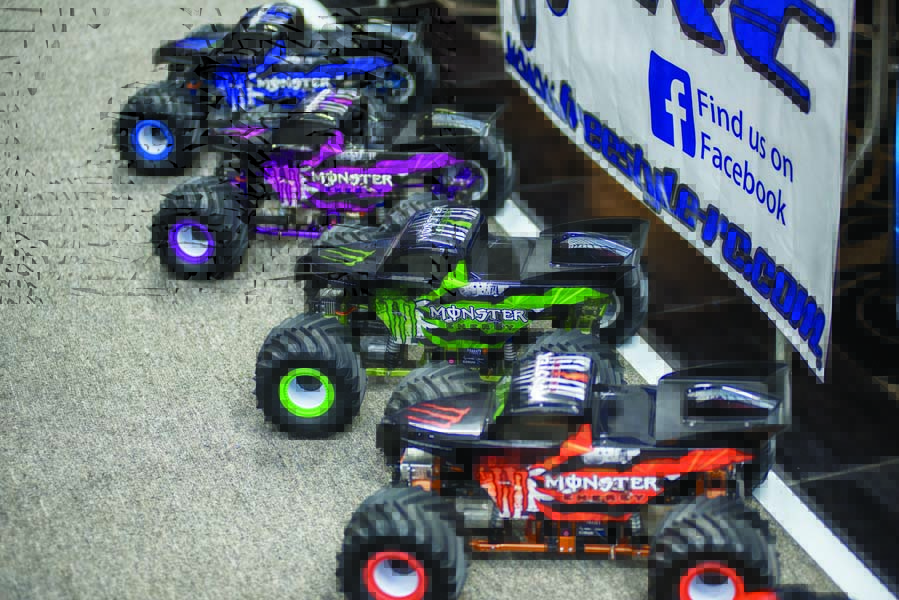 A nice lineup of color-coordinated Monster Energy liveried monster trucks.