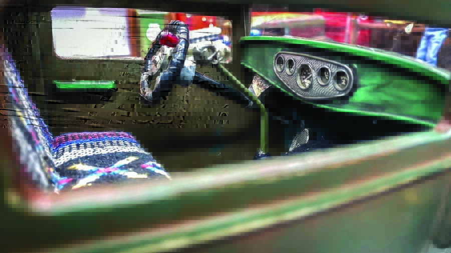 The steering wheel came from a vintage ‘60s Tonka firetruck and is wrapped in electrical tape . The dash and gauges are from a 1/8-scale model kit.